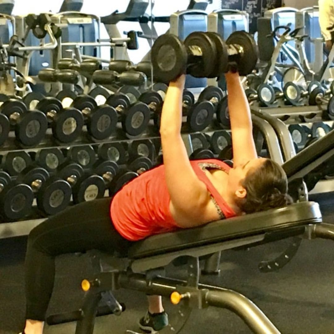 Member doing a dumbbell press