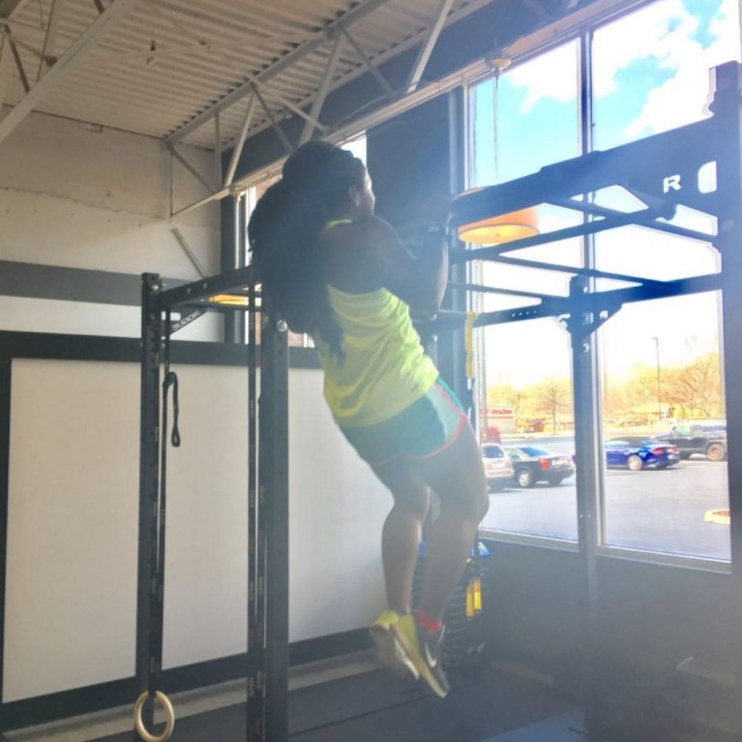 Member doing pull-ups near the windows