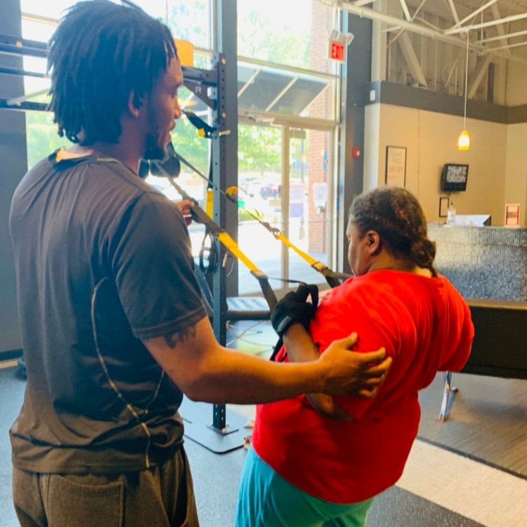 Personal trainer working with a client